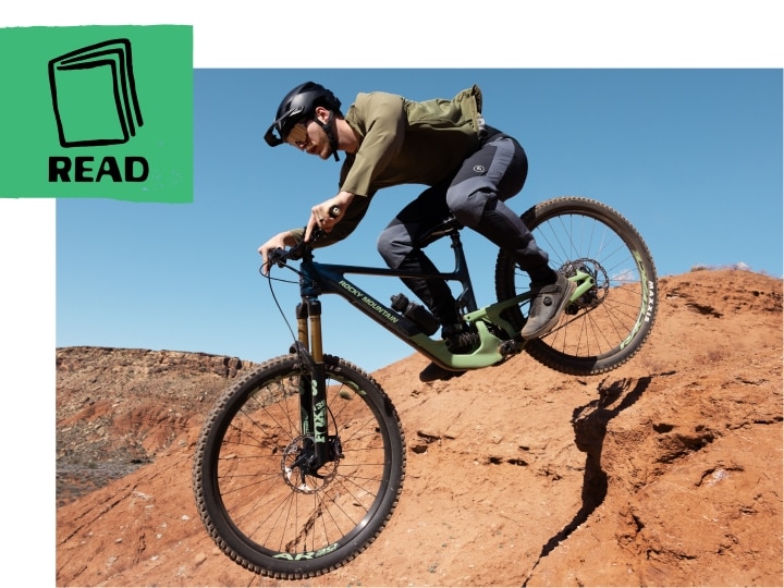 Mountain bike rider dropping through the air with a desert mesa background. 