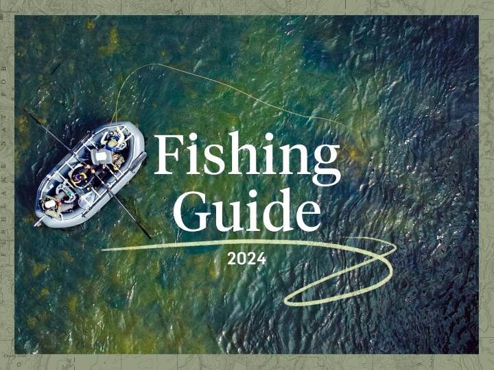 A drone shot of two people in a boat casing a fly line on a river. The words “2024, Fishing Guide” appear over the image.