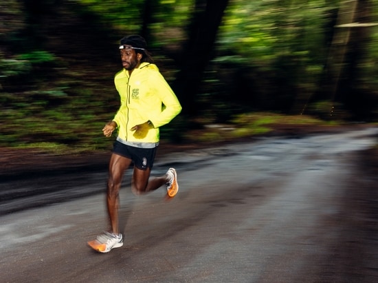 A runner on a dirt road at dawn.